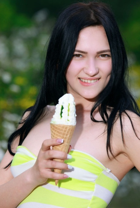 Brunette teen Indiana Blanc eats an ice cream before going nude afore bushes 69735821