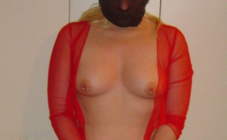 Caucasian girl shows her pierced nipples while restrained with cuffs and chain 87292100